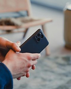 En smartphone i händerna på en person. 